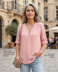 Woman in her early 50s wearing a blush pink zip-up V-neck half-sleeve blouse