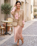 Woman in her early 50s wearing a pink open-weave crochet daisy top
