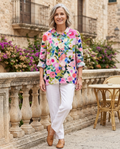 Woman in her early 50s wearing a floral print blouse